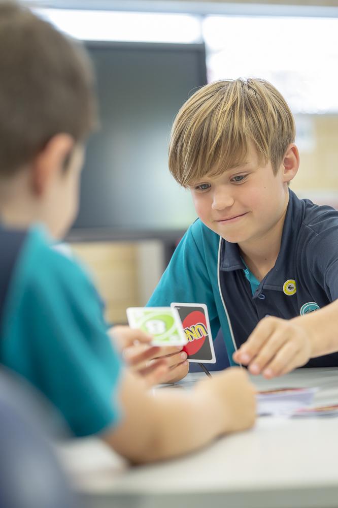 Boy play maths cards